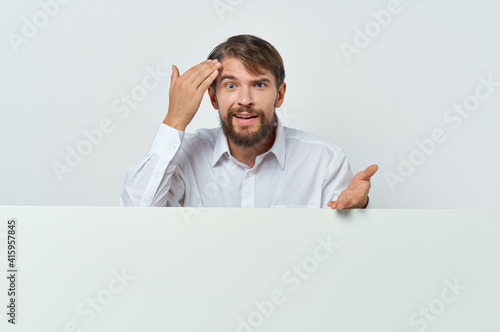 funny bearded man stands near the mockup advertising presentation