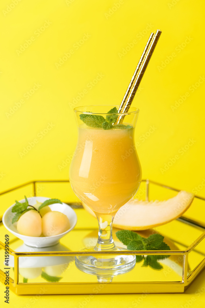 Tray with glass of melon smoothie on color background Tray with glass of melon smoothie on color background