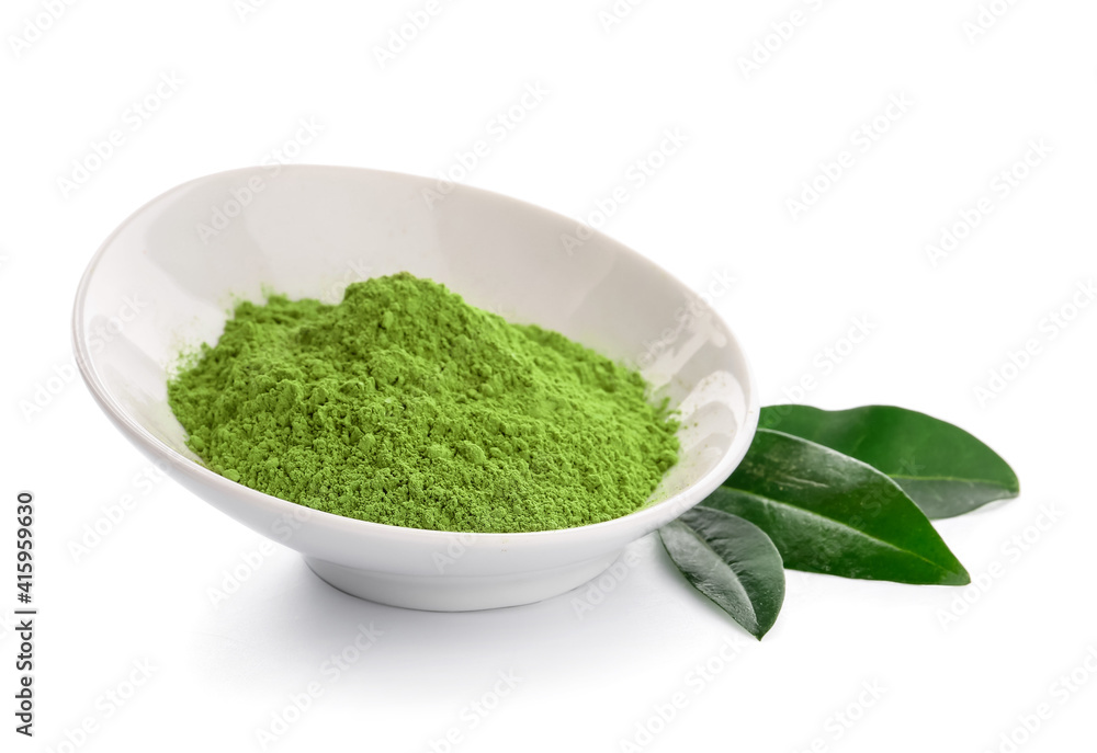 Bowl with powdered matcha tea and fresh leaves on white background Bowl with powdered matcha tea and fresh leaves on white background
