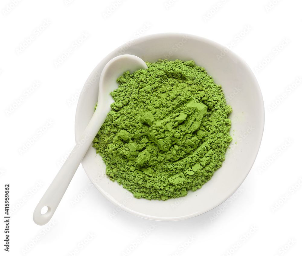 Bowl with powdered matcha tea and spoon on white background Bowl with powdered matcha tea and spoon on white background