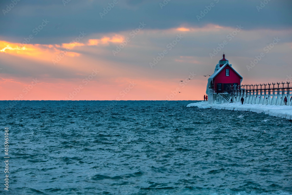 Grand Haven lighthouse sunset on Lake Michigan in winter Grand Haven lighthouse sunset on Lake Michigan in winter
