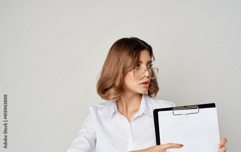 Business woman in glasses with documents in hands on a gray background Copy Space Business woman in glasses with documents in hands on a gray background Copy Space