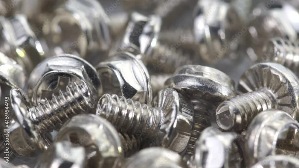 Closeup of steel bolts turning, shallow focus. Closeup of steel bolts turning, shallow focus.
