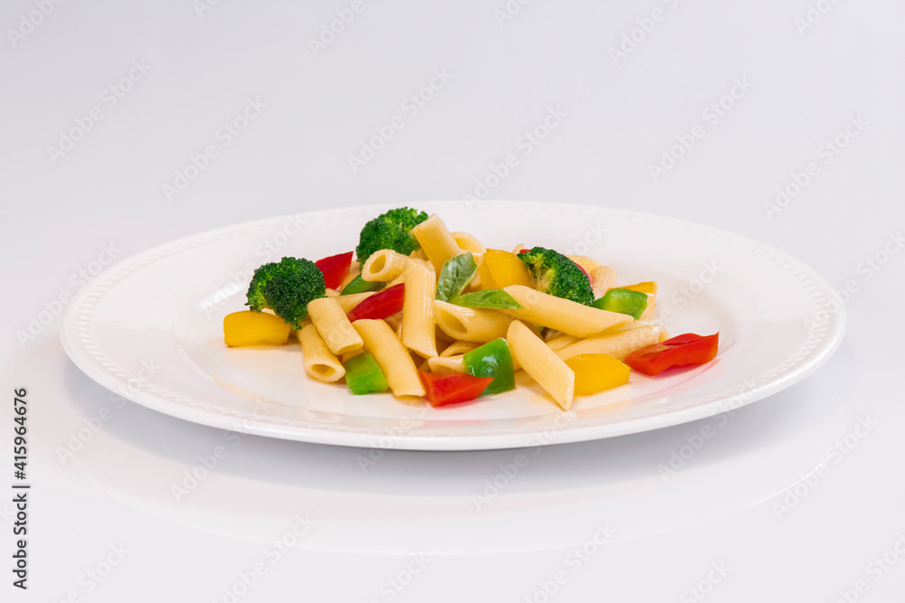 Selective focus of a delicious looking pasta salad on a plate on a light background. Healthy food and pasta concept.