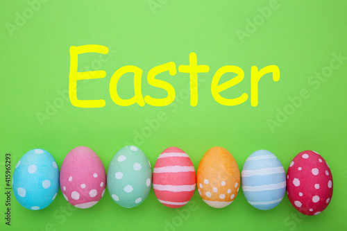 Colorful easter eggs on a green background, pastel