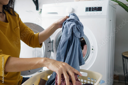 Принти на полотні close up of woman in front of the washing machine doing some laundry loading clo