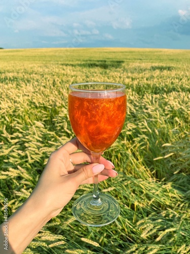 glass of wine in a field 