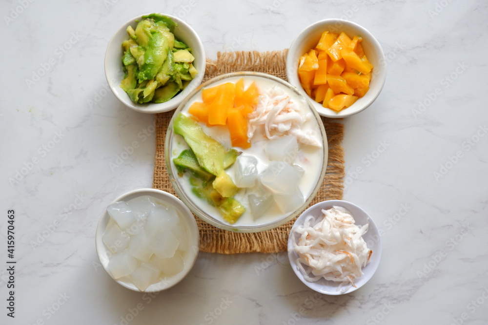 a glass of es teler or various fruits with coconut milk soup and ice cubes a glass of es teler or various fruits with coconut milk soup and ice cubes