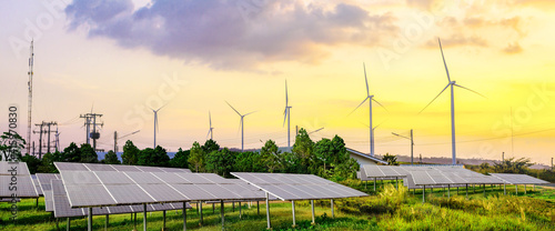 Obraz na plátne Solar cell panels and wind turbines in sunset sky for alternatively power genera