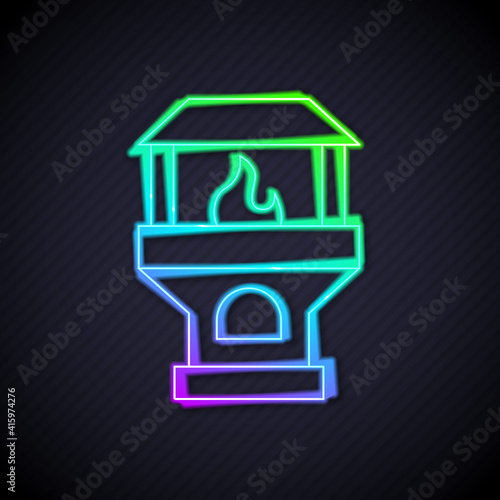 Glowing neon line Brick stove icon isolated on black background. Brick fireplace, masonry stove, stone oven icon. Vector.