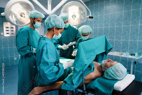 Group of surgeon team at work in operating room in hospital