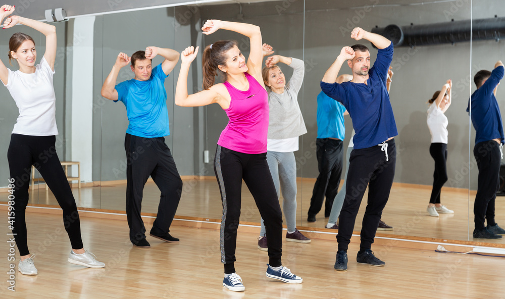 Dance class for adult people, positive young and mature men and women training in dance studio