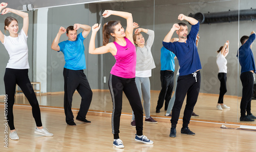 Dance class for adult people, positive young and mature men and women training in dance studio © JackF