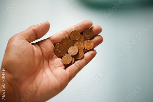 hand holding euro currency coins 