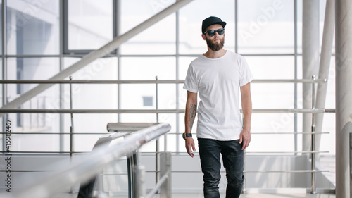 Wallpaper Mural Hipster handsome male model with glasses wearing white blank t-shirt and black jeans with space for your logo or design in casual urban style Torontodigital.ca