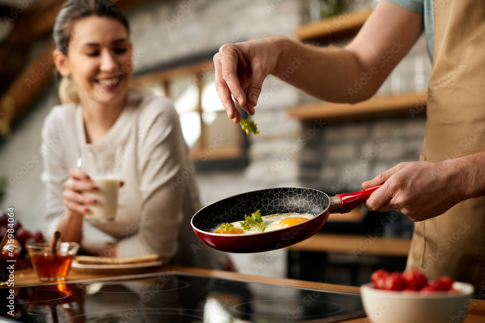 © Drazen - Close-up of man preparing breakfast for his girlfriend n the kitchen. © Drazen - Close-up of man preparing breakfast for his girlfriend n the kitchen.