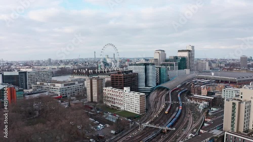 Slow dolly forward drone shot towards London eye over Waterloo train station photo