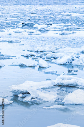 Vertical background with ice floes on a river