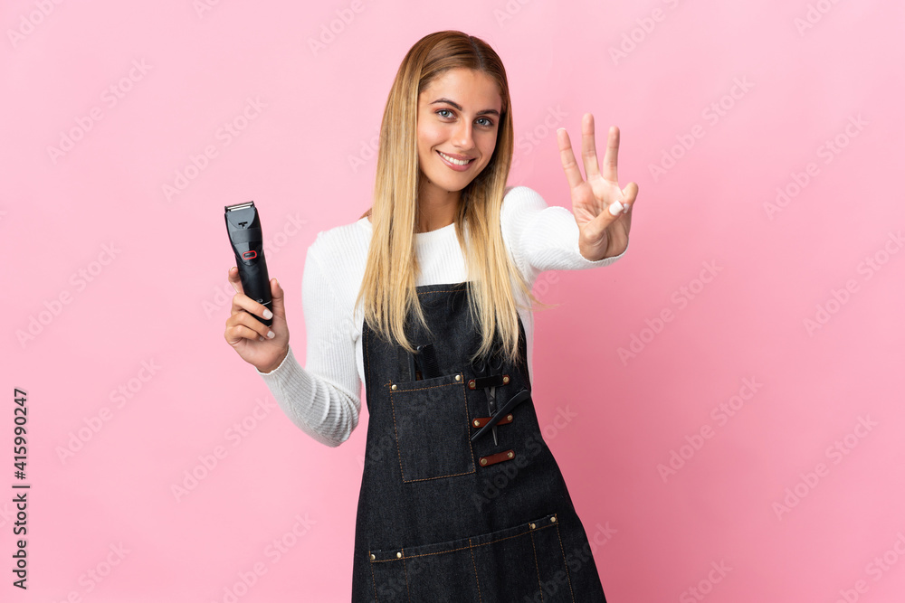 Young hairdresser woman isolated on pink background happy and counting three with fingers Young hairdresser woman isolated on pink background happy and counting three with fingers