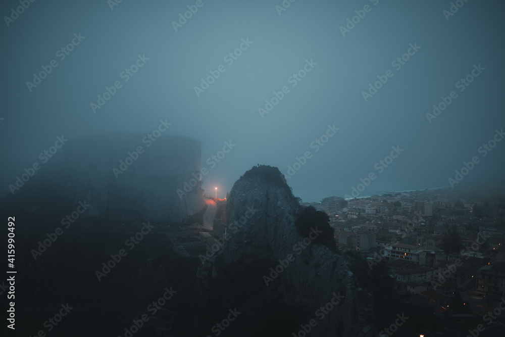 Castle of Carafa in Roccella Jonica inside of the fog. Calabria, Italy