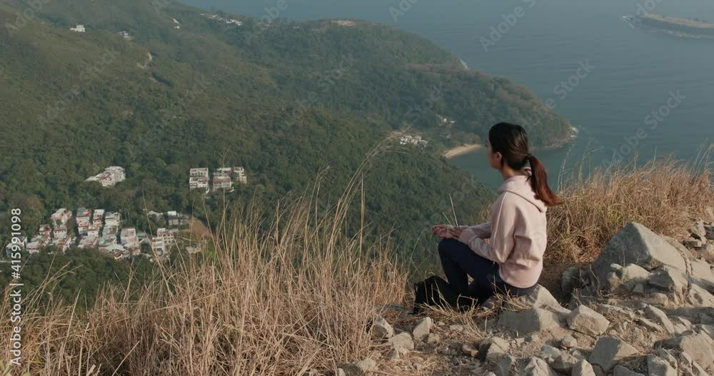 Woman sit on the top of the mountain Woman sit on the top of the mountain