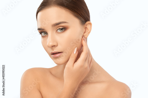 Portrait of a beautiful brunette girl with healthy clean skin and fresh make-up. Aesthetic cosmetology and makeup concept.