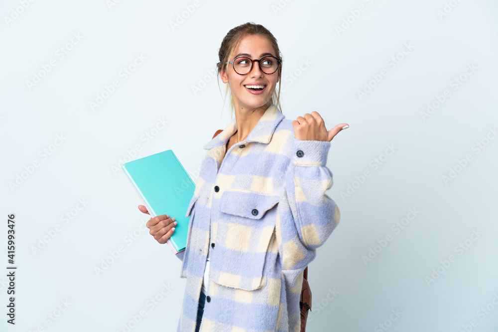Young student woman isolated on white background pointing to the side to present a product Young student woman isolated on white background pointing to the side to present a product