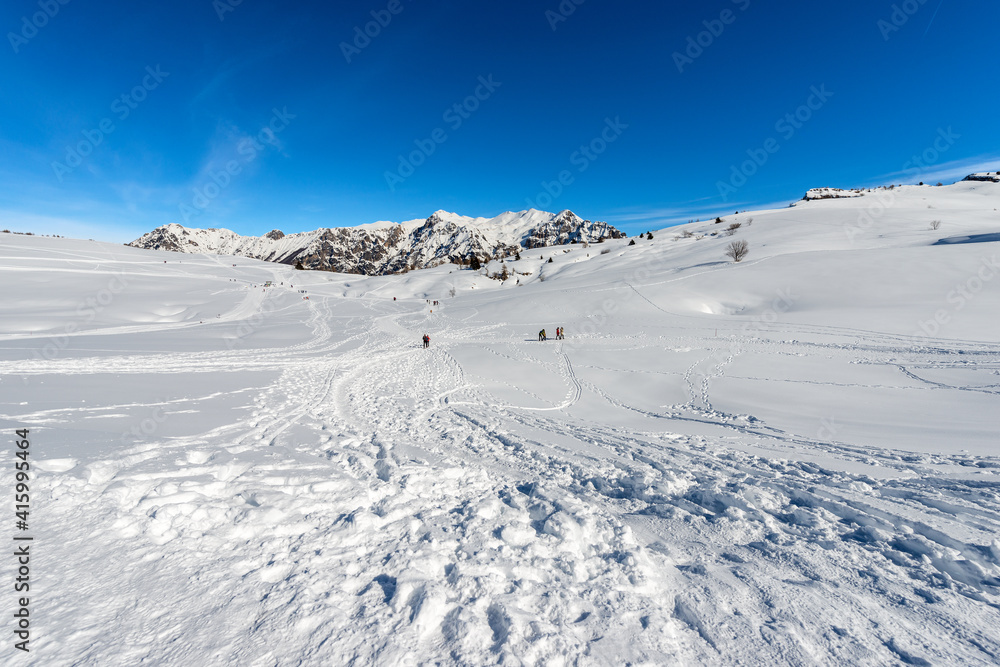 Mountain range of the Monte Carega in winter with snow, called the small Dolomites and the Altopiano della Lessinia (Lessinia High Plateau). Veneto and Trentino Alto Adige, Italy, Europe.