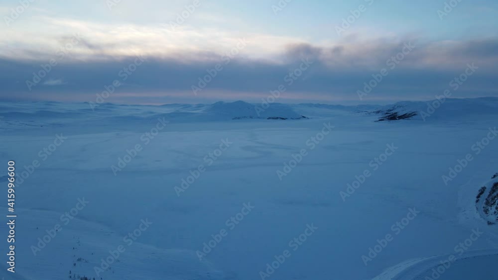 Sunset over frozen lake in Southern Norway. Zooming in drone footage Sunset over frozen lake in Southern Norway. Zooming in drone footage