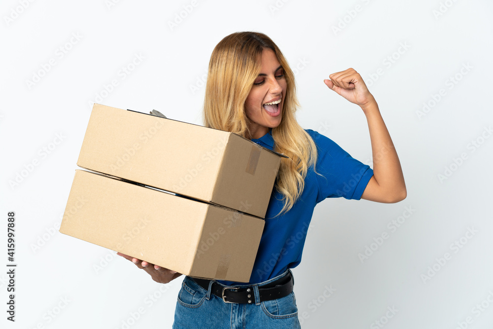 Young blonde Uruguayan delivery woman isolated on white background celebrating a victory Young blonde Uruguayan delivery woman isolated on white background celebrating a victory