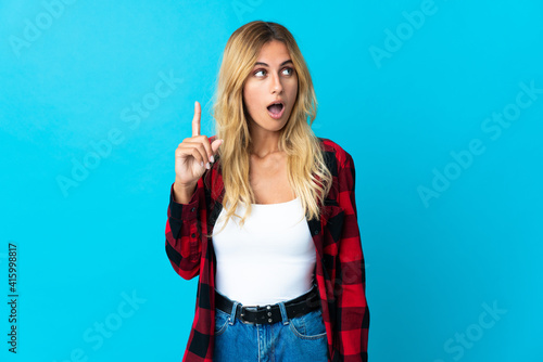 Young blonde Uruguayan woman over isolated background intending to realizes the solution while lifting a finger up