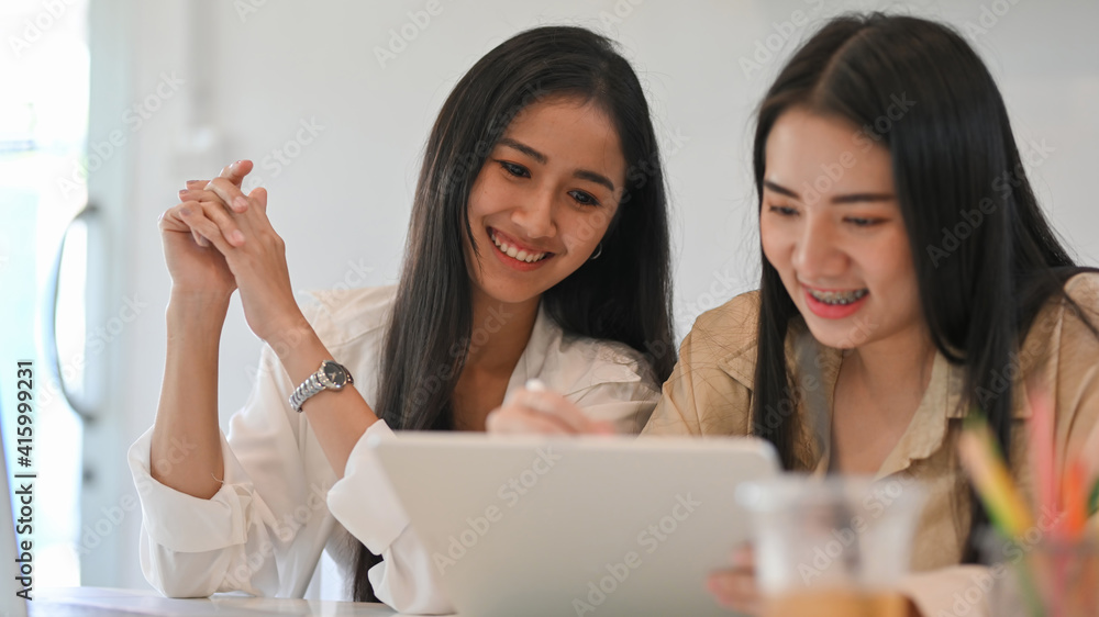 Close up view of group of businesswomen discussing on their project Close up view of group of businesswomen discussing on their project
