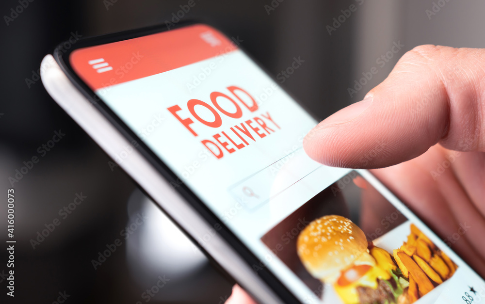 Restaurant food delivery service in phone. Take away menu in digital mobile  app. Man ordering takeout pizza or burger online. Fast lunch delivered  home. Person using smartphone and mockup application. foto de