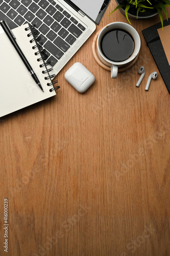 Creative flat lay workspace with laptop, coffee cup, notebook, accessories and copy space