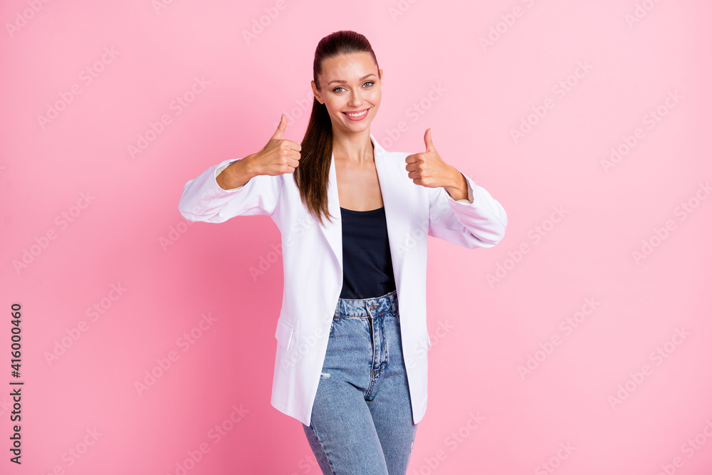 Photo of sweet shiny young lady wear white jacket showing thumbs up two hands arms isolated pastel pink color background Photo of sweet shiny young lady wear white jacket showing thumbs up two hands arms isolated pastel pink color background