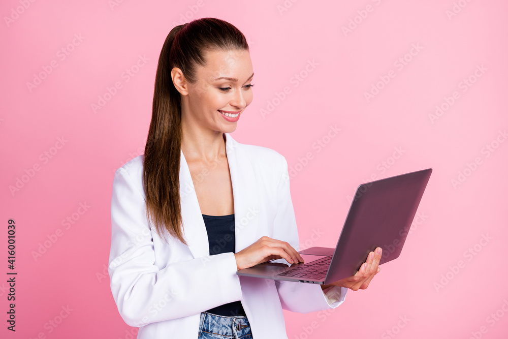 Photo of happy businesswoman hold laptop work wear white blazer isolated on pastel pink color background Photo of happy businesswoman hold laptop work wear white blazer isolated on pastel pink color background
