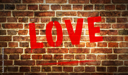 Love spray painted inscription on the brick wall