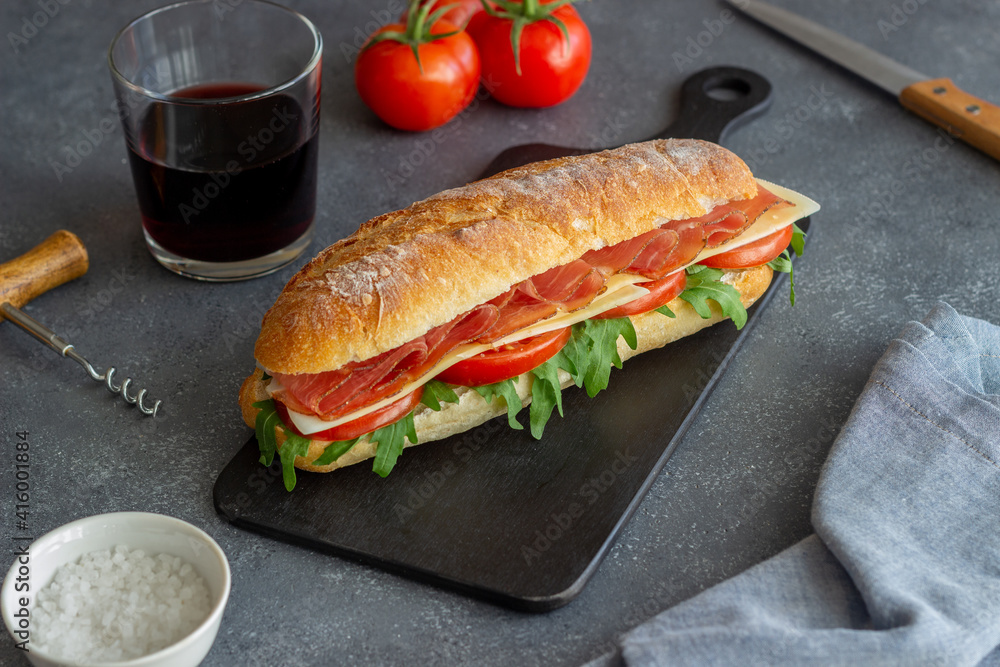 Sandwich with prosciutto, tomatoes, arugula and cheese. Healthy eating. Diet. Sandwich with prosciutto, tomatoes, arugula and cheese. Healthy eating. Diet.
