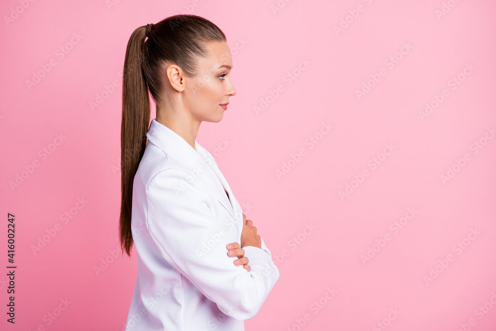 Photo of serious charming young lady wear white jacket arms folded looking empty space isolated pink color background Photo of serious charming young lady wear white jacket arms folded looking empty space isolated pink color background