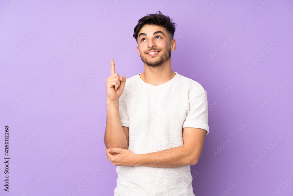 Arabian handsome man over isolated background pointing up a great idea Arabian handsome man over isolated background pointing up a great idea