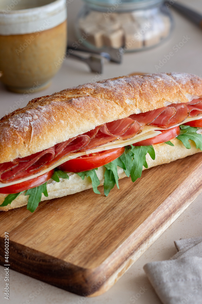 Sandwich with prosciutto, tomatoes, arugula and cheese. Healthy eating. Diet. Sandwich with prosciutto, tomatoes, arugula and cheese. Healthy eating. Diet.