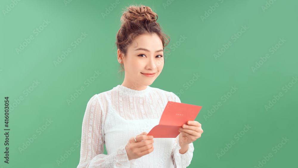 Attractive woman with postcard, on green background Attractive woman with postcard, on green background