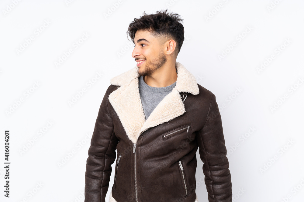Arabian handsome man over isolated background looking to the side and smiling Arabian handsome man over isolated background looking to the side and smiling