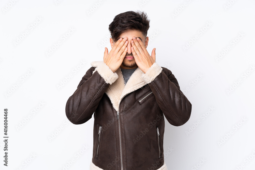 Arabian handsome man over isolated background covering eyes by hands Arabian handsome man over isolated background covering eyes by hands