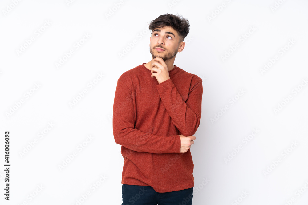 Arabian handsome man over isolated background and looking up Arabian handsome man over isolated background and looking up