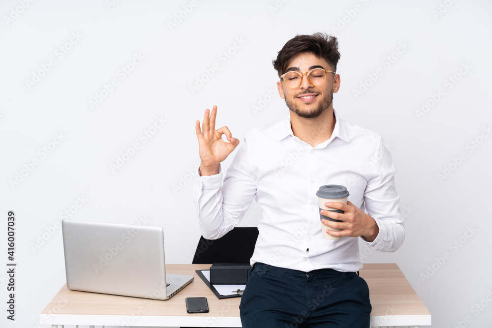 Arabian man in a office isolated on white background in zen pose Arabian man in a office isolated on white background in zen pose