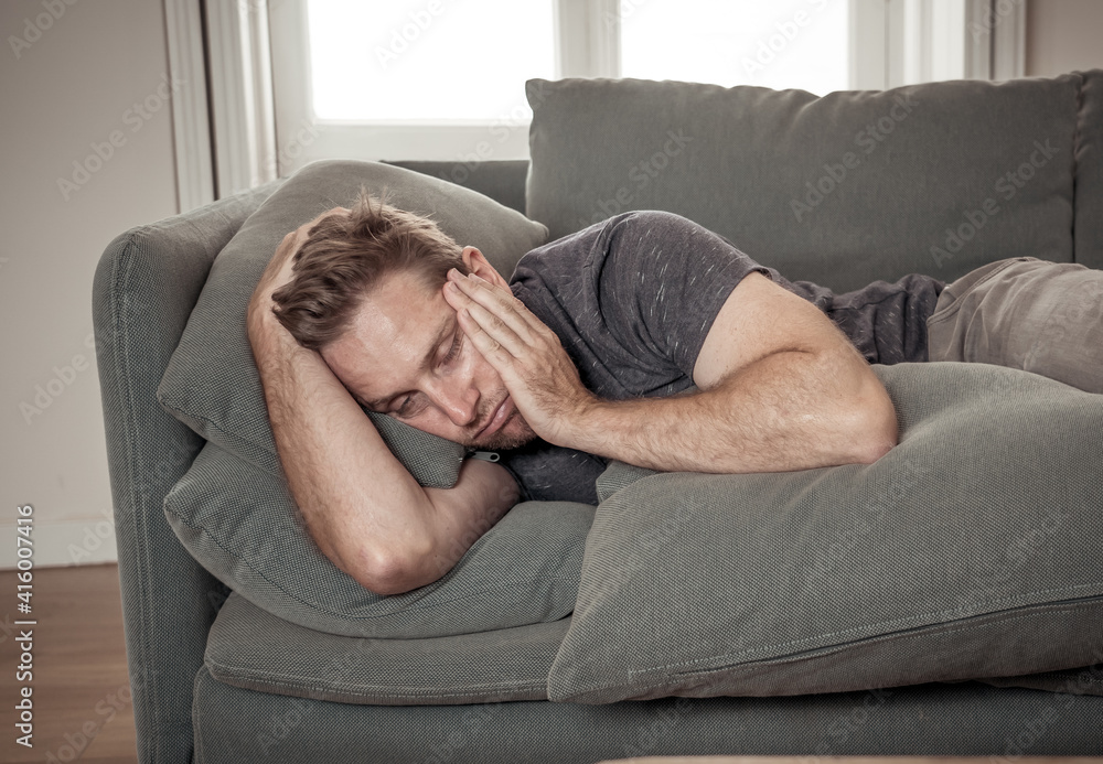 Young man suffering from depression feeling lonely, distressed and hopeless isolated at home Young man suffering from depression feeling lonely, distressed and hopeless isolated at home
