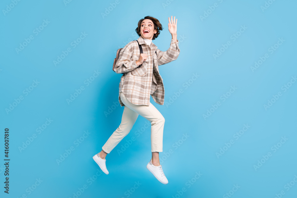 Profile full size photo of optimistic cool lady run wave hand with bag wear shirt trousers isolated on teal background