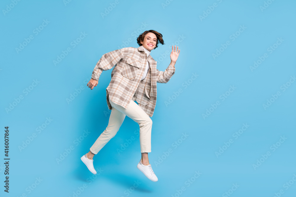 Profile full size photo of optimistic cool lady run wave hand wear shirt trousers sneakers isolated on teal color background Profile full size photo of optimistic cool lady run wave hand wear shirt trousers sneakers isolated on teal color background
