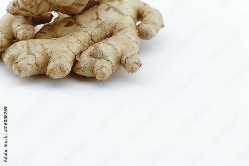 Fresh ginger on a white isolated background - close-up photo